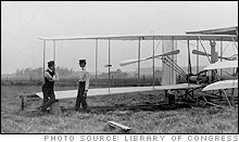 Wilbur and Orville Wright with their second powered machine; Huffman Prairie, Dayton, Ohio.