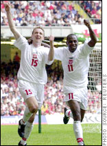 Emmanuel Olisadebe (right) celebrates a goal for Poland