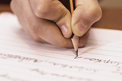 Child's hand writing on paper