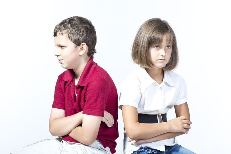 Two kids in conflict facing away from one another